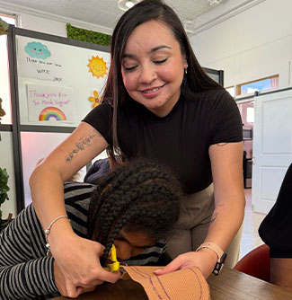 A support coordinator helping a member with an art project.